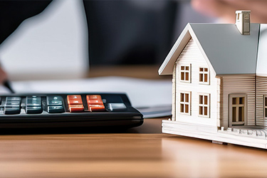calculator and a mini house | hoa financial management